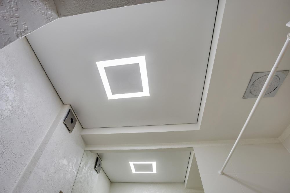 suspended ceiling with halogen spots lamps drywall construction empty room apartment house stretch ceiling white complex shape