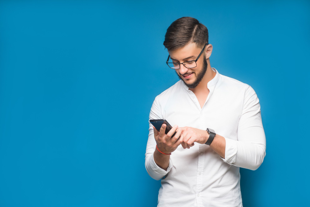 businessman using mobile phone app texting blue
